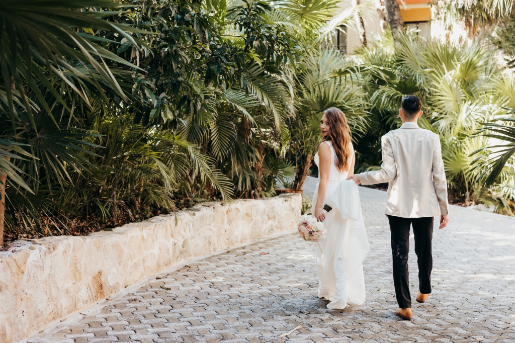 editorial portrait of bride and groom walking away during a tropical destination wedding