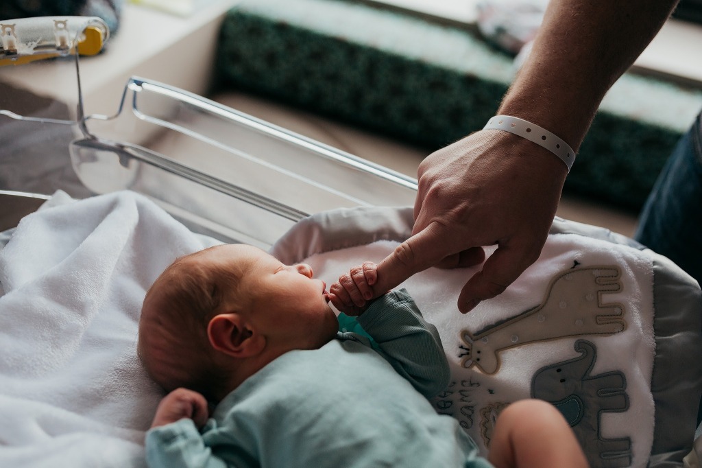Hospital Newborn photos.  Baby holding dad's finger for the first time.